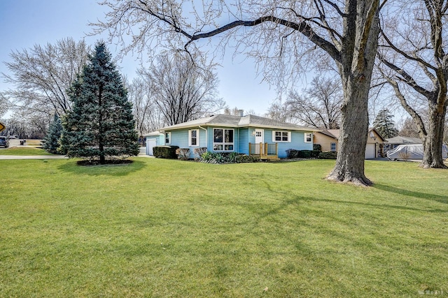 ranch-style home featuring a garage, a chimney, and a front yard