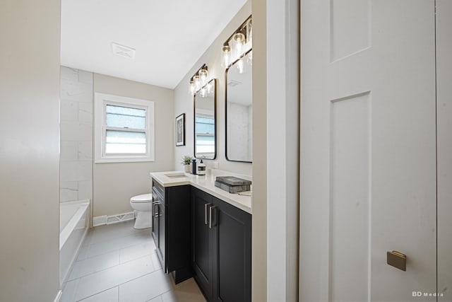 bathroom with visible vents, toilet, vanity, and tile patterned flooring