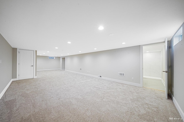 below grade area featuring visible vents, recessed lighting, baseboards, and carpet floors