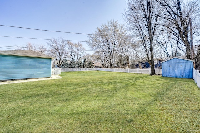 view of yard featuring a shed, an outdoor structure, and a fenced backyard