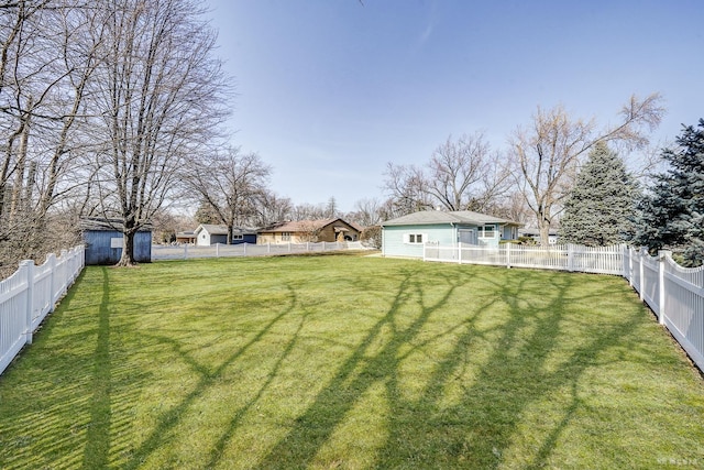 view of yard featuring an outbuilding and a fenced backyard