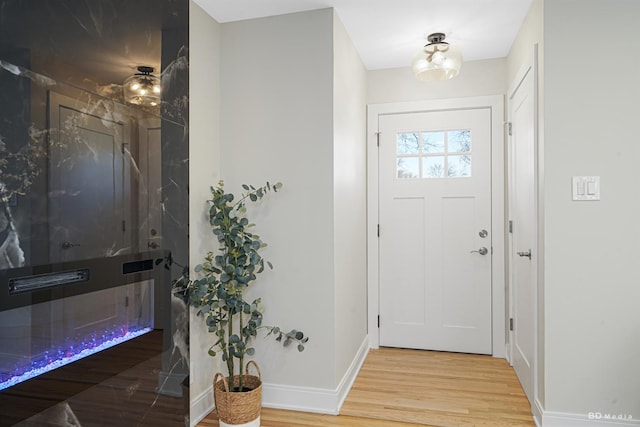 foyer entrance featuring wood finished floors and baseboards