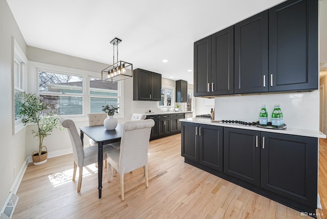 dining space with recessed lighting, visible vents, baseboards, and light wood-style floors