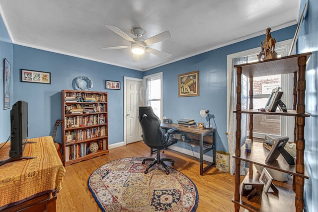 office area with ornamental molding, wood finished floors, a ceiling fan, and baseboards