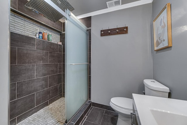 full bath with tile patterned flooring, toilet, vanity, visible vents, and tiled shower