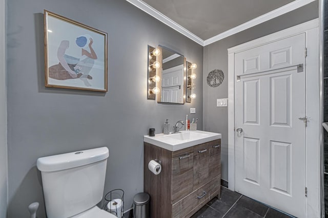 bathroom featuring crown molding, vanity, toilet, and tile patterned floors