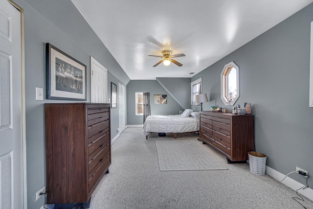 bedroom featuring baseboards, ceiling fan, and light colored carpet