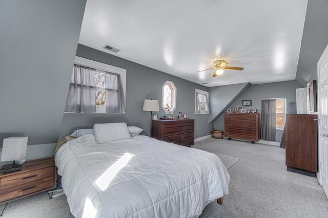 bedroom with visible vents, a ceiling fan, carpet flooring, vaulted ceiling, and baseboards