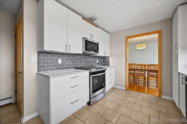 kitchen featuring visible vents, baseboards, white cabinetry, appliances with stainless steel finishes, and backsplash