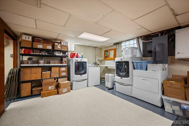 clothes washing area featuring laundry area, electric panel, and washer and dryer