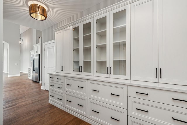 interior space featuring dark wood-style flooring and baseboards