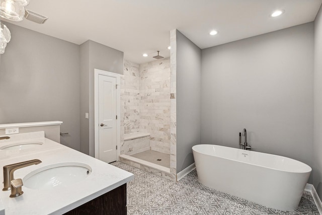 bathroom featuring double vanity, a freestanding tub, a sink, and tiled shower