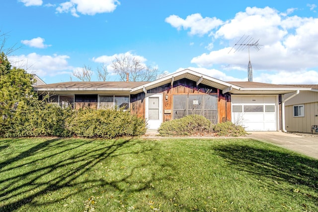 ranch-style house featuring a garage, driveway, and a front lawn