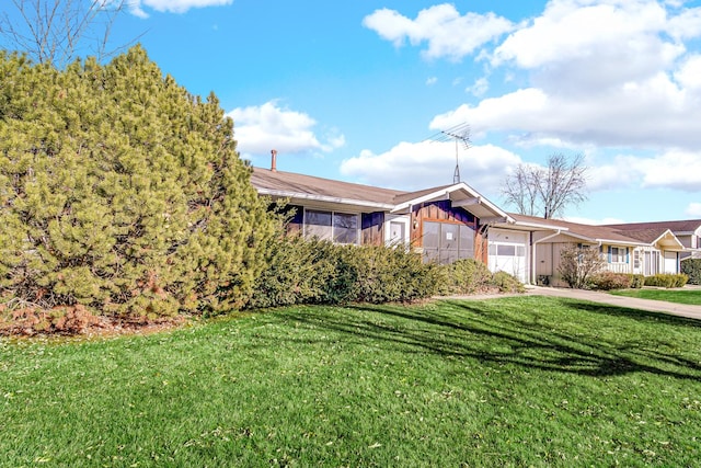 single story home featuring an attached garage, driveway, and a front yard