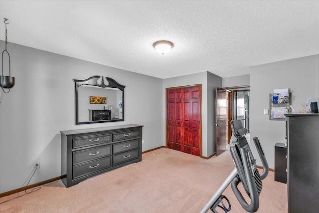 interior space with light carpet, a textured ceiling, and baseboards