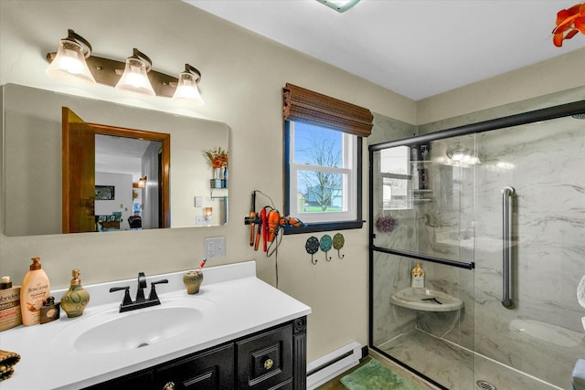 full bathroom with a stall shower, a baseboard heating unit, and vanity