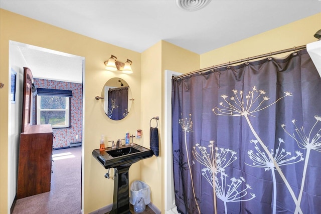 bathroom featuring baseboards and visible vents