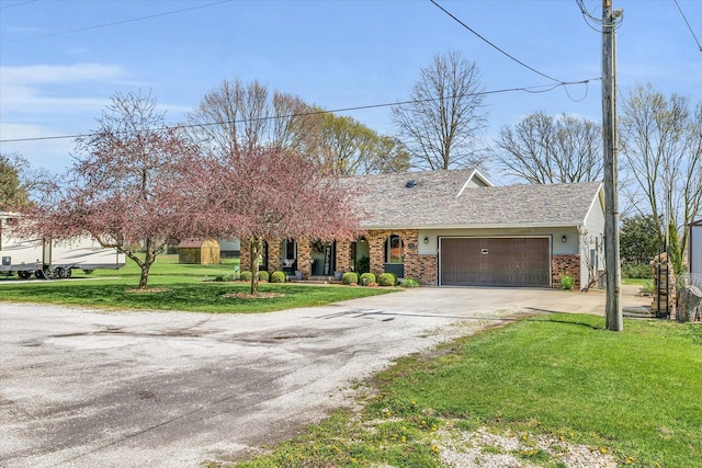 view of front of property featuring an attached garage, a front lawn, concrete driveway, and brick siding