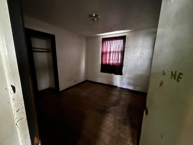 unfurnished bedroom with concrete floors and a closet