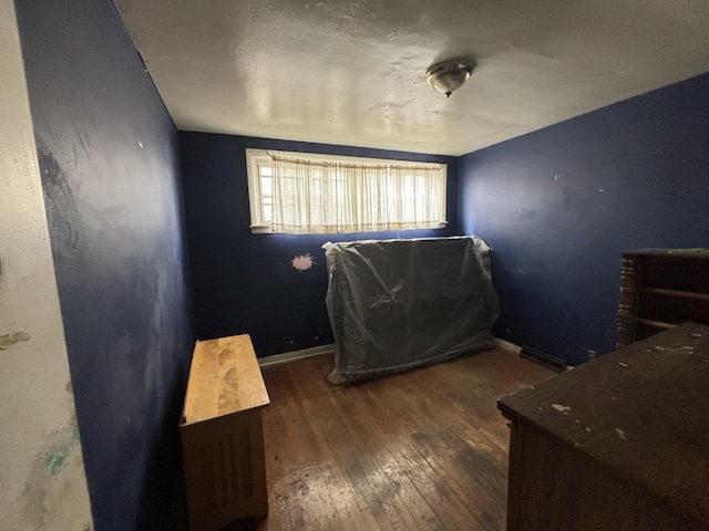 bedroom featuring wood-type flooring and baseboards