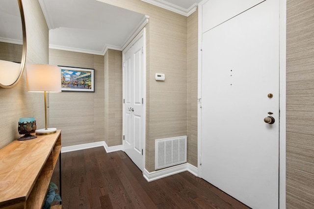 entryway with ornamental molding, dark wood-style flooring, visible vents, and baseboards