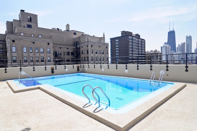 community pool featuring a patio area and a city view