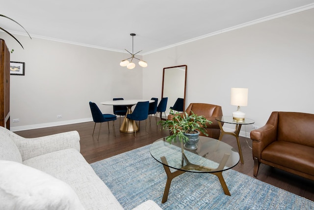 living area featuring a notable chandelier, baseboards, wood finished floors, and ornamental molding