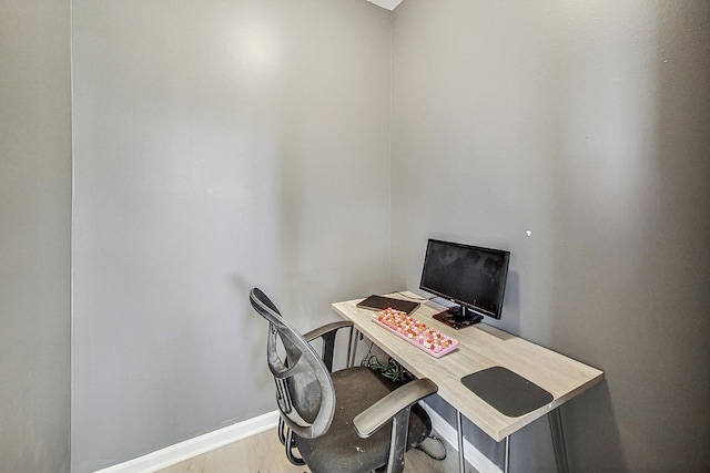 home office with wood finished floors and baseboards