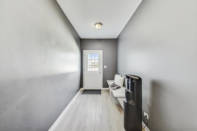 entryway featuring visible vents, light wood-style flooring, and baseboards