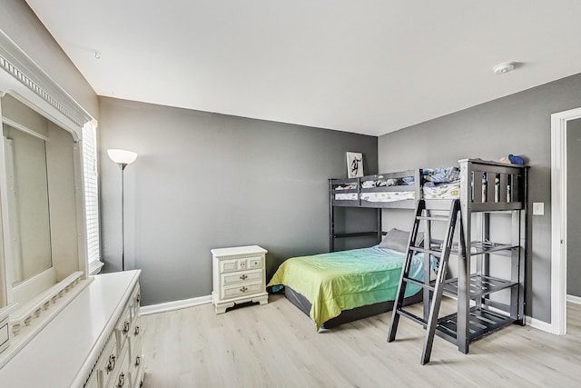 bedroom featuring baseboards and light wood-style floors