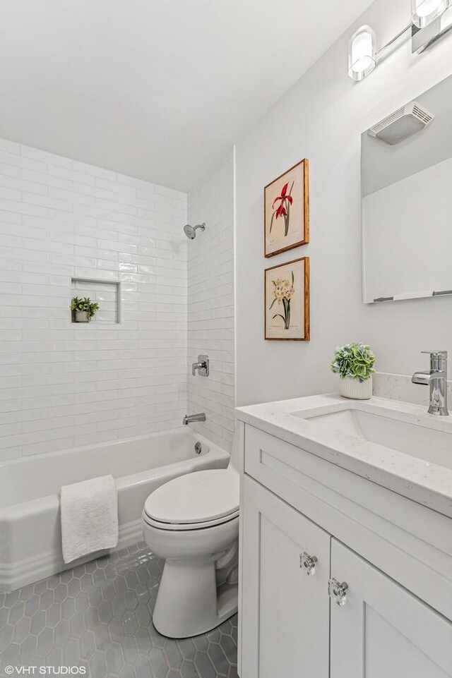 full bathroom with bathtub / shower combination, visible vents, toilet, vanity, and tile patterned floors