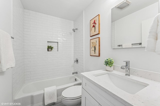 bathroom with bathtub / shower combination, visible vents, vanity, and toilet