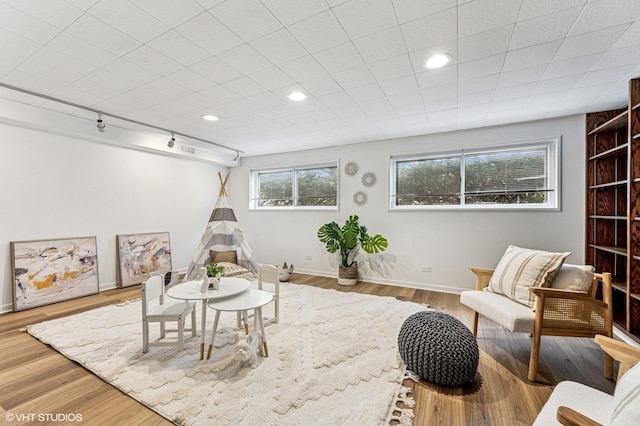 game room with recessed lighting, wood finished floors, visible vents, baseboards, and rail lighting