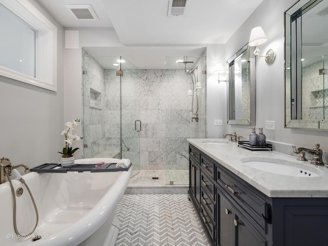 bathroom with a stall shower, visible vents, and a sink