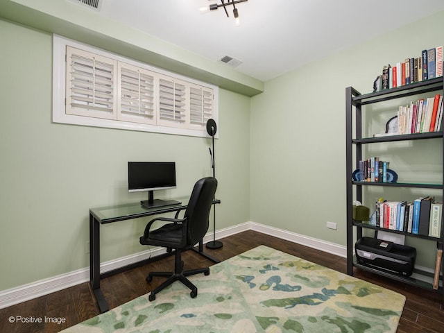 office featuring dark wood-style flooring, visible vents, and baseboards