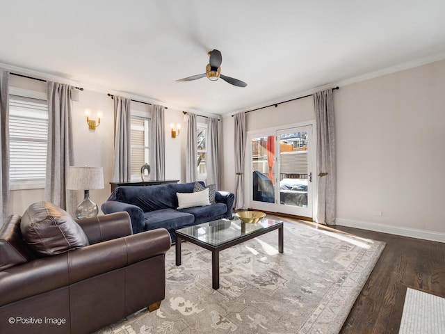 living room featuring a ceiling fan, baseboards, a wealth of natural light, and wood finished floors