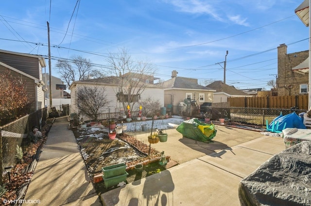 back of property with a patio area, a fenced backyard, and an outdoor structure