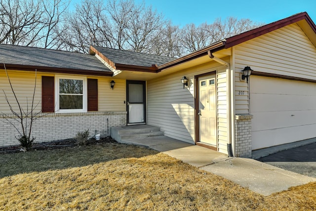 view of front of home featuring a garage and brick siding