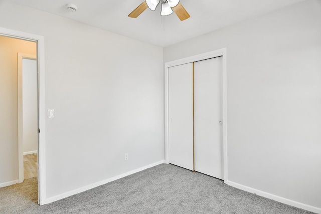 unfurnished bedroom featuring a ceiling fan, carpet, baseboards, and a closet