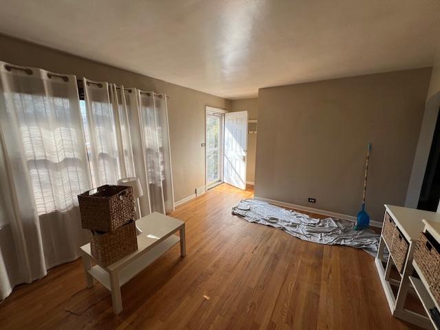 interior space with baseboards and wood finished floors