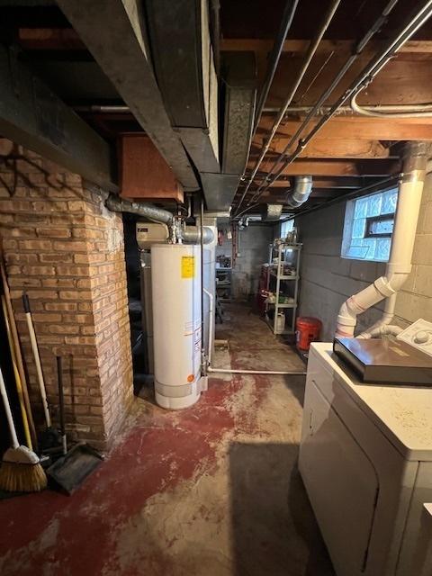 basement featuring gas water heater and washer / dryer