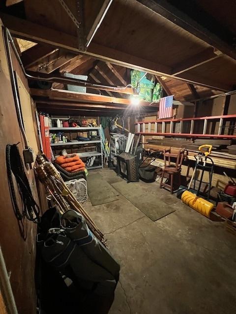 interior space featuring concrete flooring and vaulted ceiling