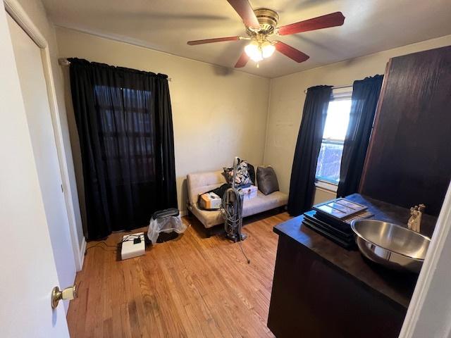 bedroom featuring wood finished floors and ceiling fan