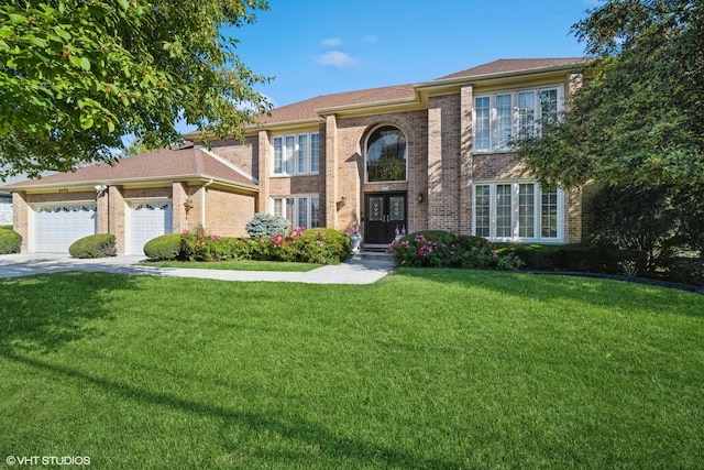 view of front of house featuring a garage, french doors, brick siding, and a front yard