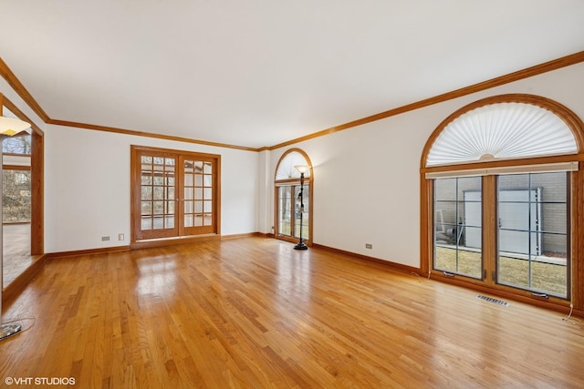 unfurnished living room with french doors, visible vents, light wood-style flooring, and baseboards