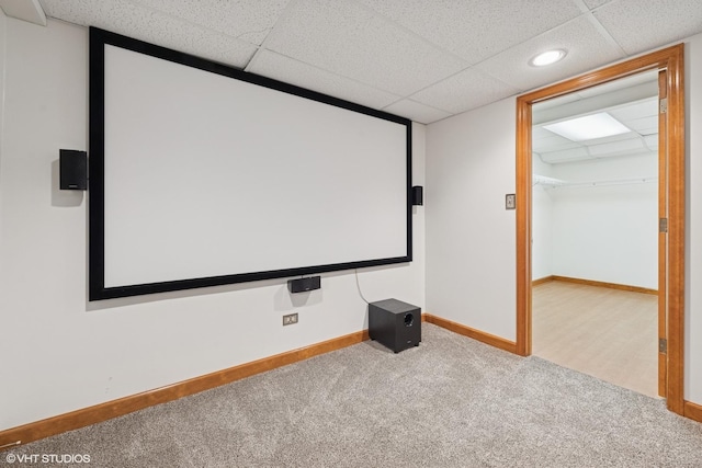 cinema room with carpet floors, recessed lighting, a paneled ceiling, and baseboards