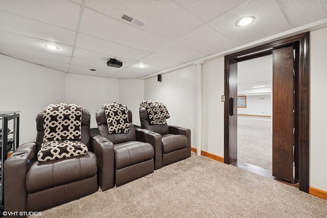 home theater with carpet floors, baseboards, and visible vents