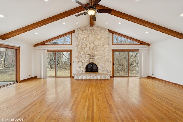 unfurnished living room with a stone fireplace, light wood-type flooring, and beam ceiling