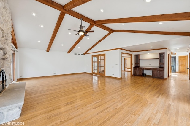 unfurnished living room featuring french doors, visible vents, a fireplace, and light wood finished floors