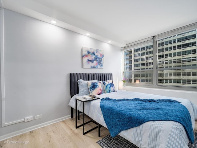 bedroom with recessed lighting, baseboards, and wood finished floors